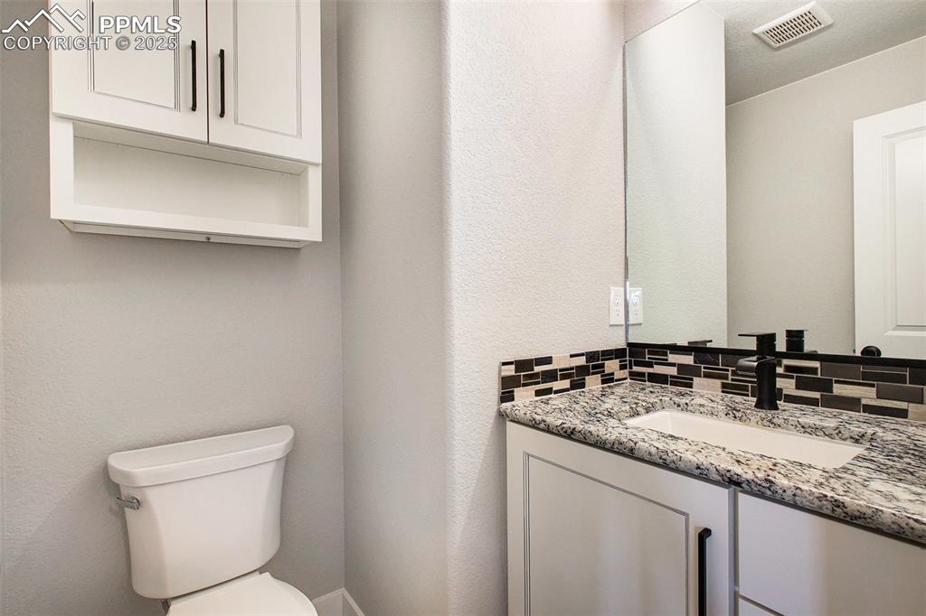 Image 11 of 20: Lovely half bathroom on main level across from laundry room