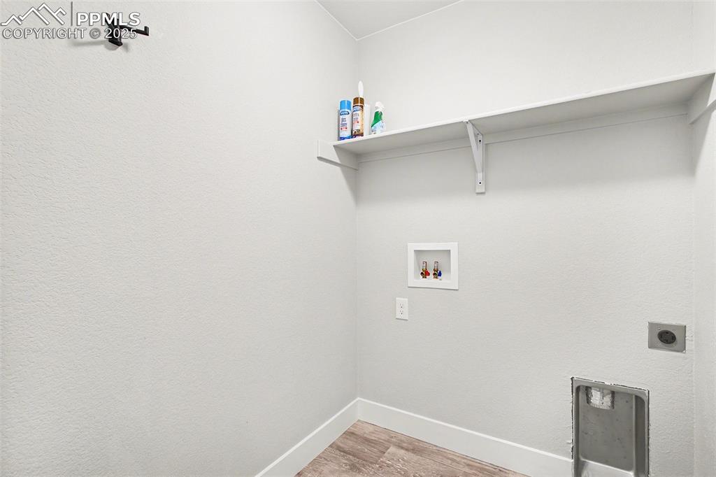 Image 12 of 20: Large laundry room right off garage and across from half bathroom 
