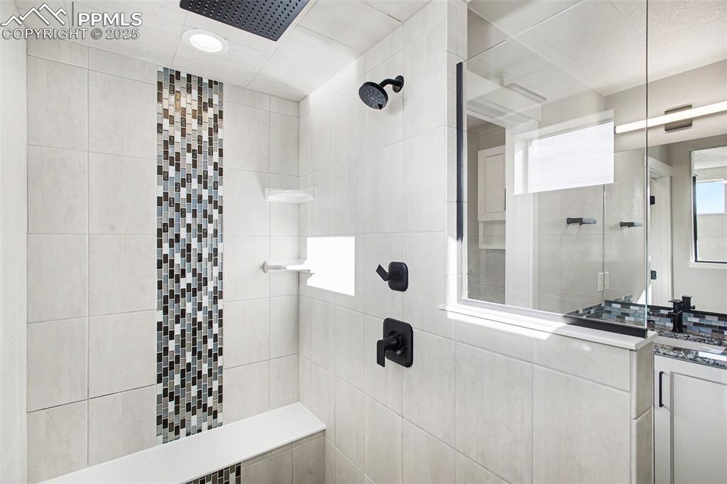 Image 15 of 20: Outstanding primary bathroom shower with multiple shower heads, completely 