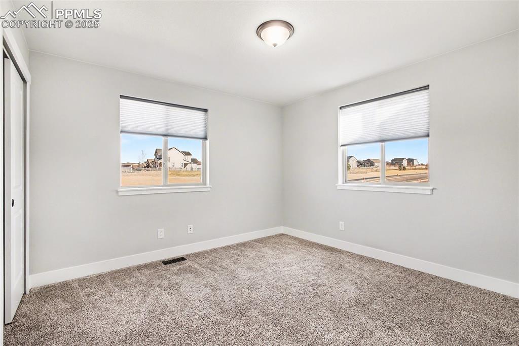 Image 19 of 20: Nice space for guest bedroom which is light and bright