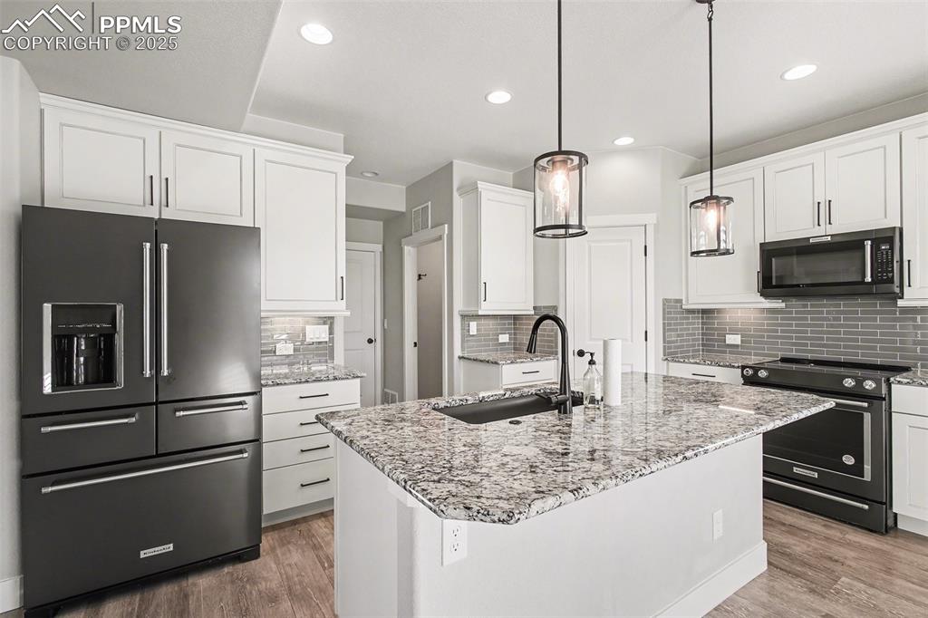 Image 5 of 20: Gourmet kitchen with top of the line Kitchen Aid appliances, granite, and f