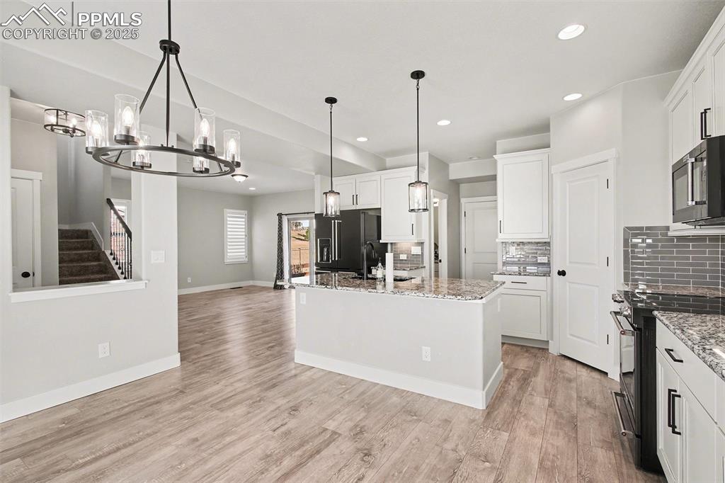 Image 6 of 20: Beautiful kitchen with island and eat in dining area