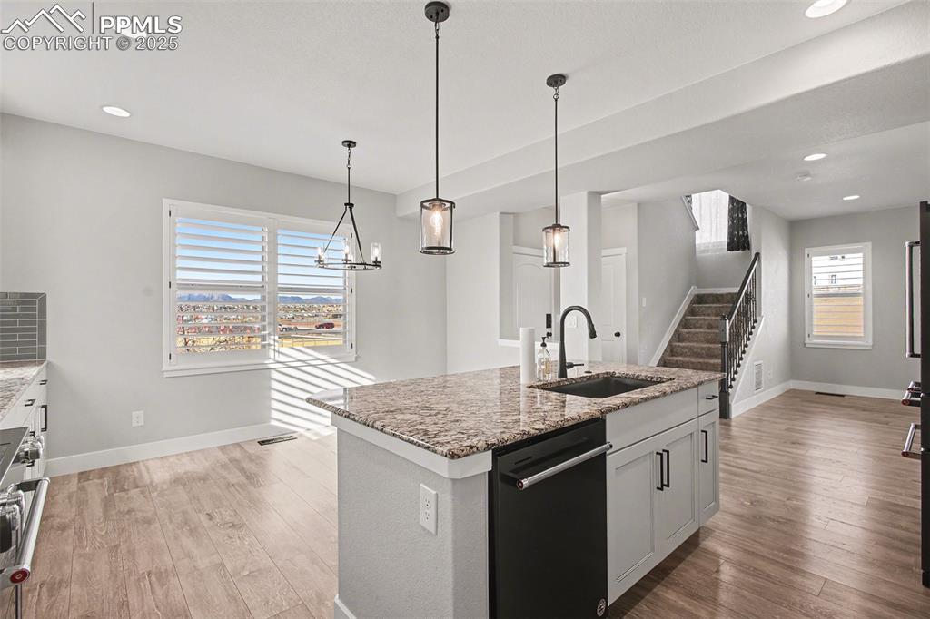 Image 7 of 20: Kitchen showing eat in area and stairs to upper level - and the great views