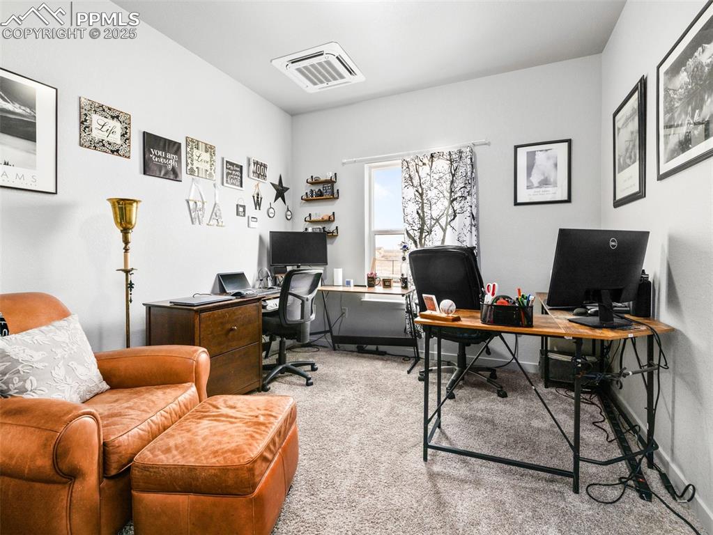 Image 12 of 25: Office space featuring light carpet and baseboards