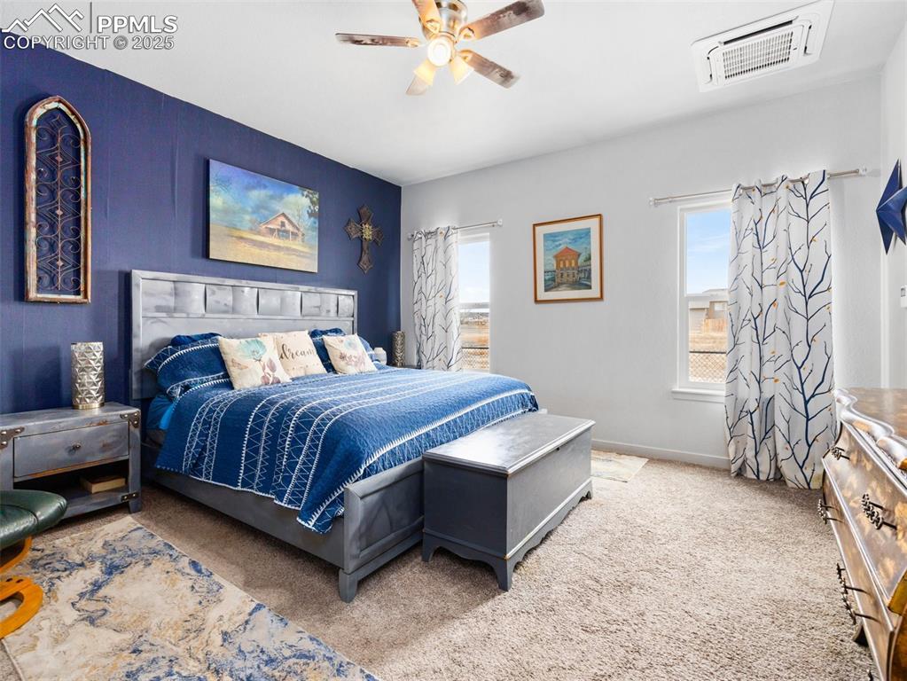 Image 14 of 25: Carpeted bedroom featuring a ceiling fan and baseboards