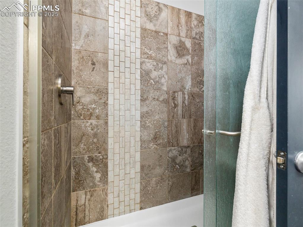 Image 17 of 25: Bathroom featuring a shower stall