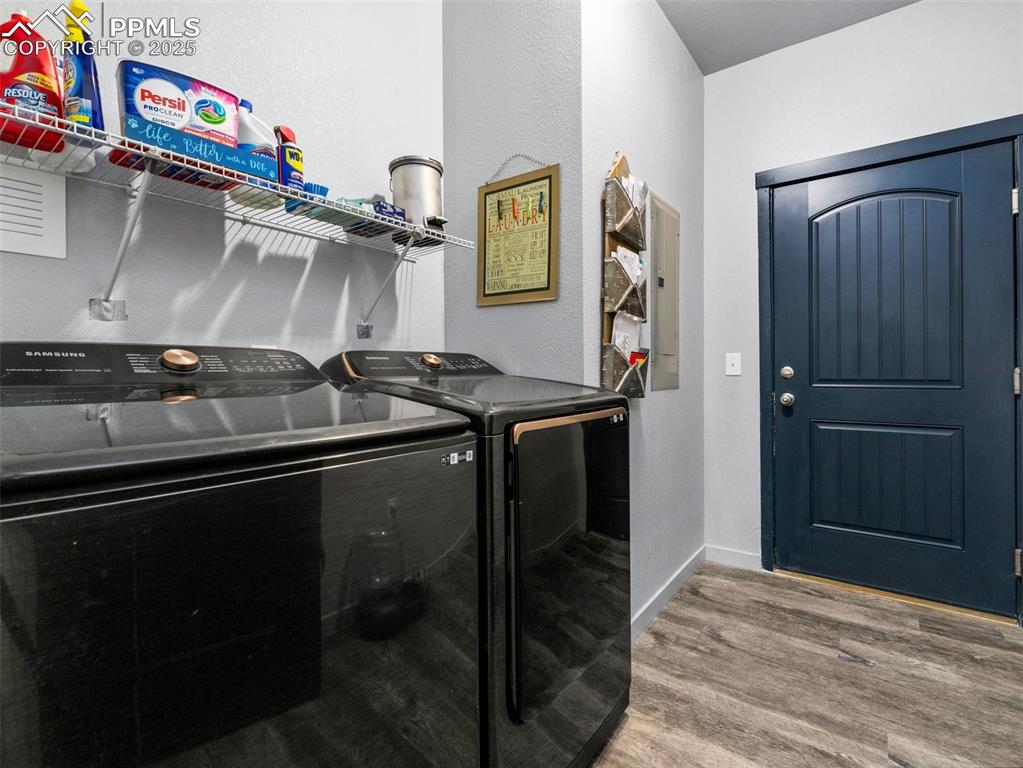 Image 19 of 25: Laundry room featuring washer and dryer and wood finished floors