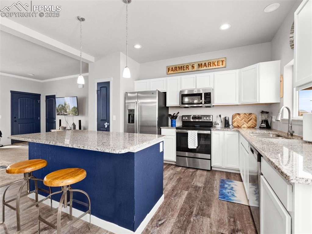 Image 7 of 25: Kitchen featuring stainless steel appliances, dark wood-type flooring, a ki
