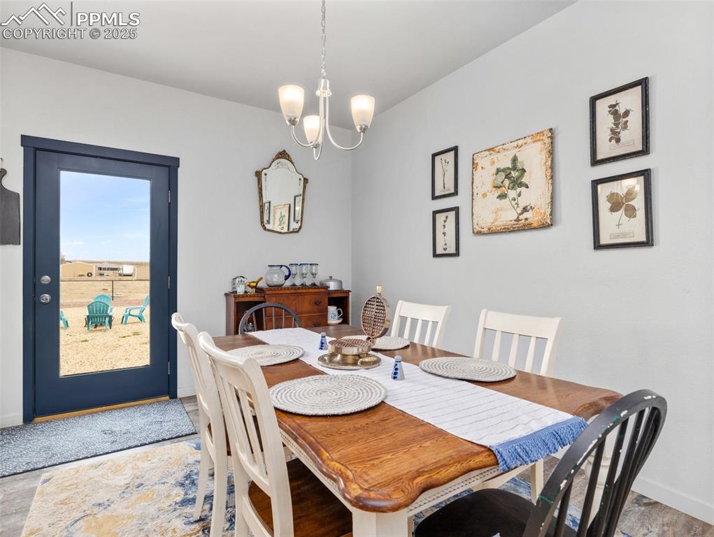 Image 9 of 25: Dining space with a chandelier and light wood-style flooring