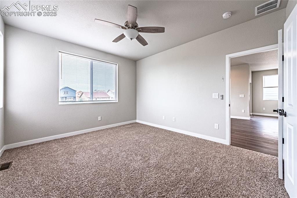 Image 16 of 39: Carpeted spare room featuring a ceiling fan and a textured ceiling