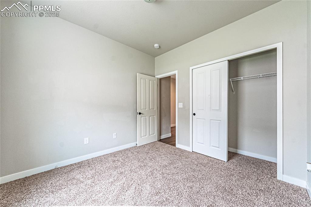 Image 17 of 39: Unfurnished bedroom with carpet flooring and a closet