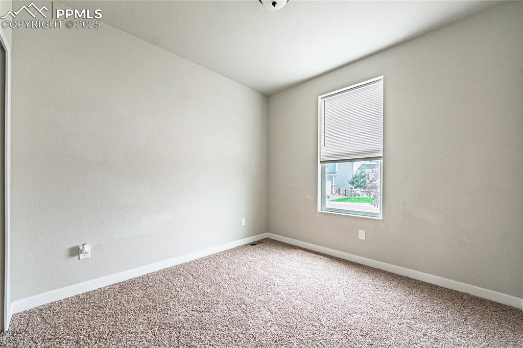 Image 18 of 39: Carpeted spare room featuring baseboards
