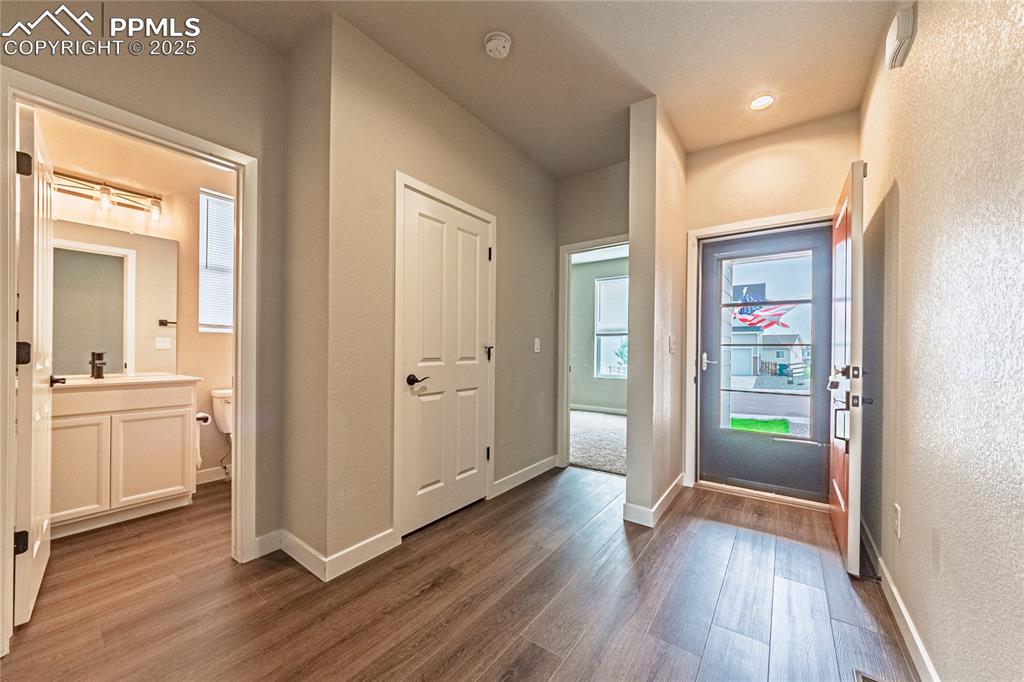 Image 2 of 39: Entryway featuring baseboards and dark wood finished floors