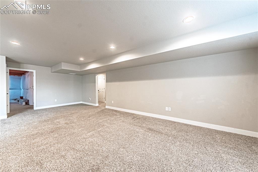 Image 23 of 39: Carpeted spare room featuring baseboards and recessed lighting