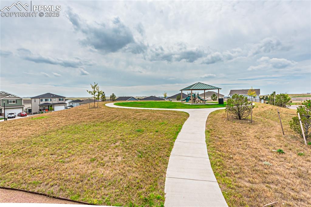 Image 37 of 39: View of community featuring a yard and a residential view