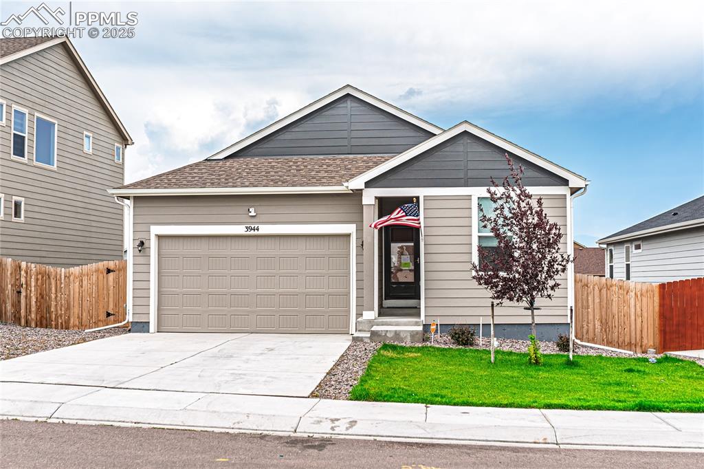 Image 39 of 39: Ranch-style home with an attached garage, driveway, and a shingled roof