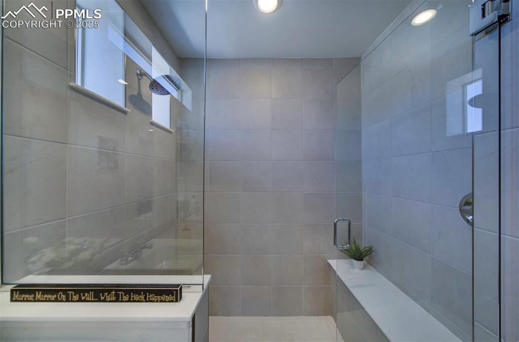 Image 33 of 50: shower with a bench