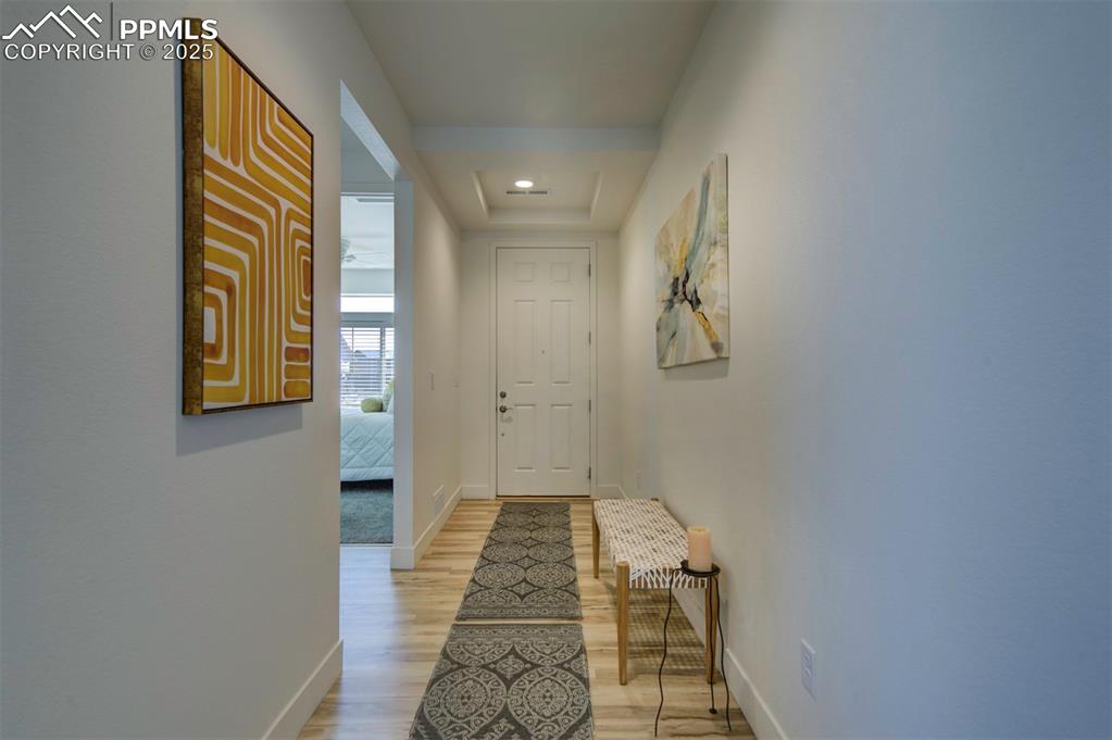 Image 7 of 50: long front entrance with guest bed, bath and linen closet