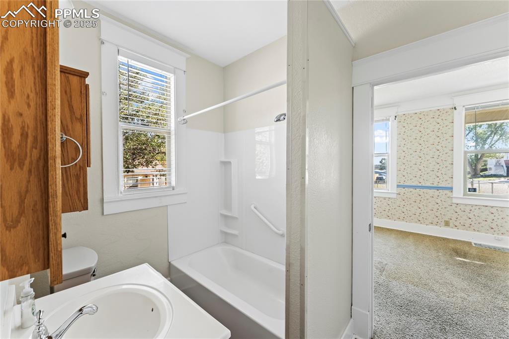 Image 10 of 27: Bathroom featuring bathtub / shower combination and vanity