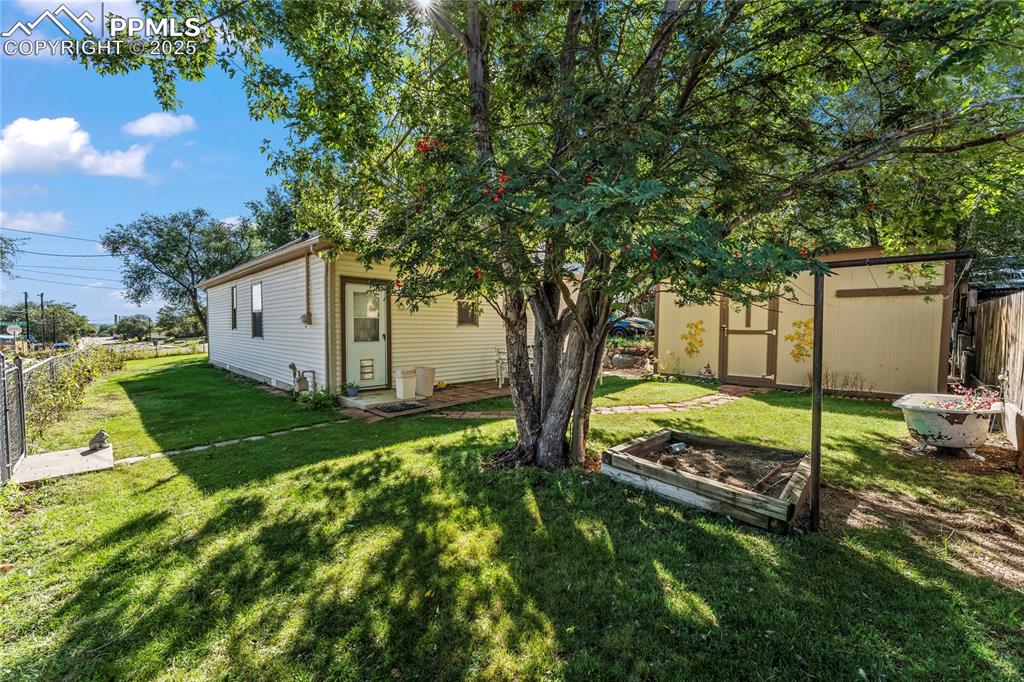 Image 22 of 27: View of yard with a garden and a shed
