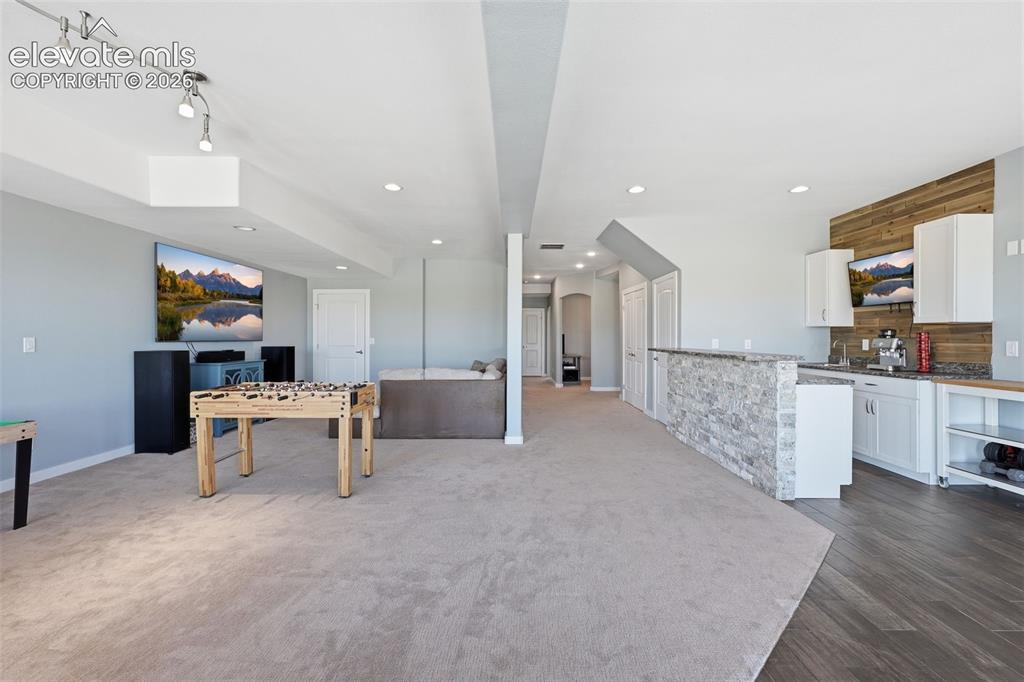 Image 19 of 27: Basement wet bar with additional prep and entertaining space