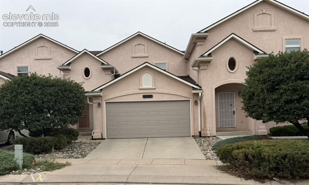 Caption: Stucco exterior with multiple gables and arched entryways