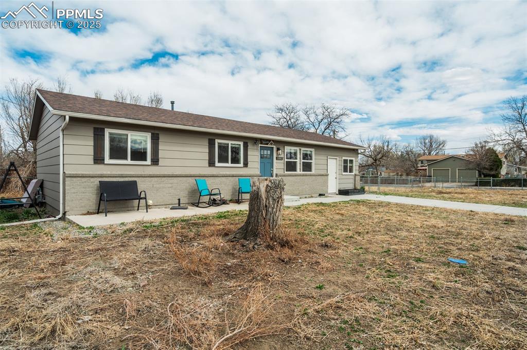 Image 2 of 29: Ranch-style house with a patio area and brick siding