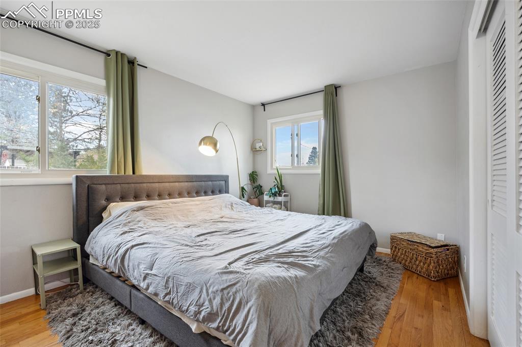 Image 14 of 39: Bedroom with baseboards, wood finished floors, and a closet