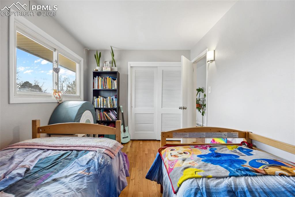 Image 18 of 39: Bedroom with light wood finished floors and a closet