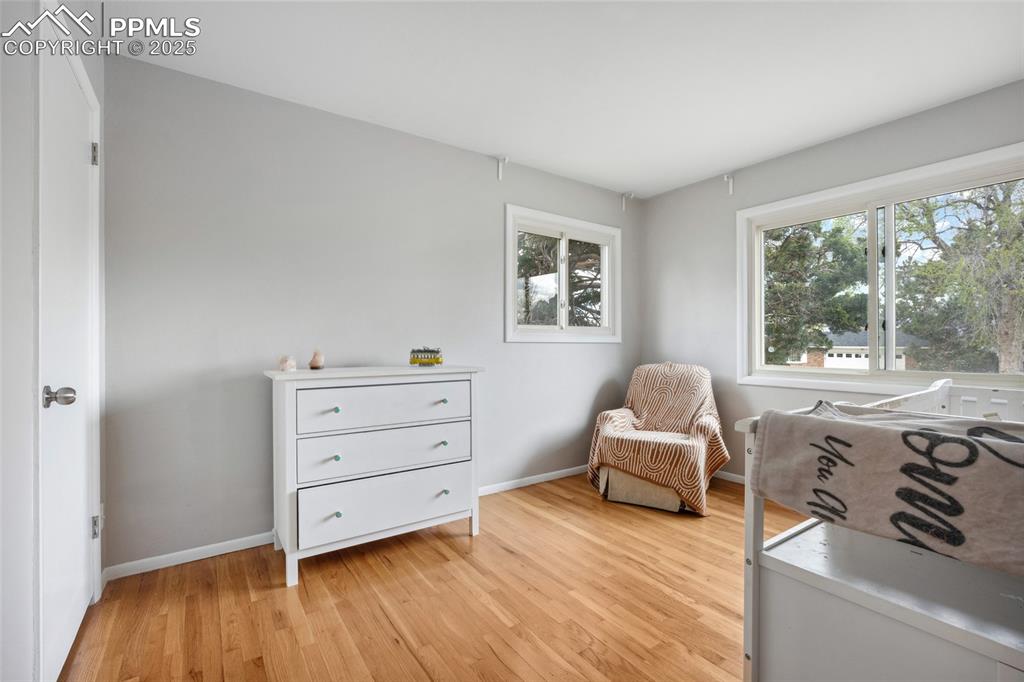 Image 19 of 39: Living area featuring baseboards and light wood-style flooring