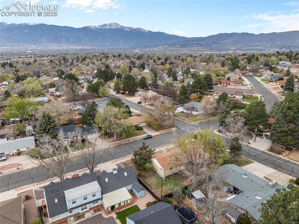 Image 2 of 39: Birds eye view of property with a mountain view and a residential view