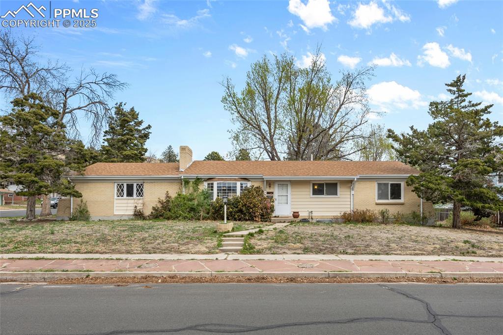 Image 3 of 39: Single story home with brick siding and a chimney