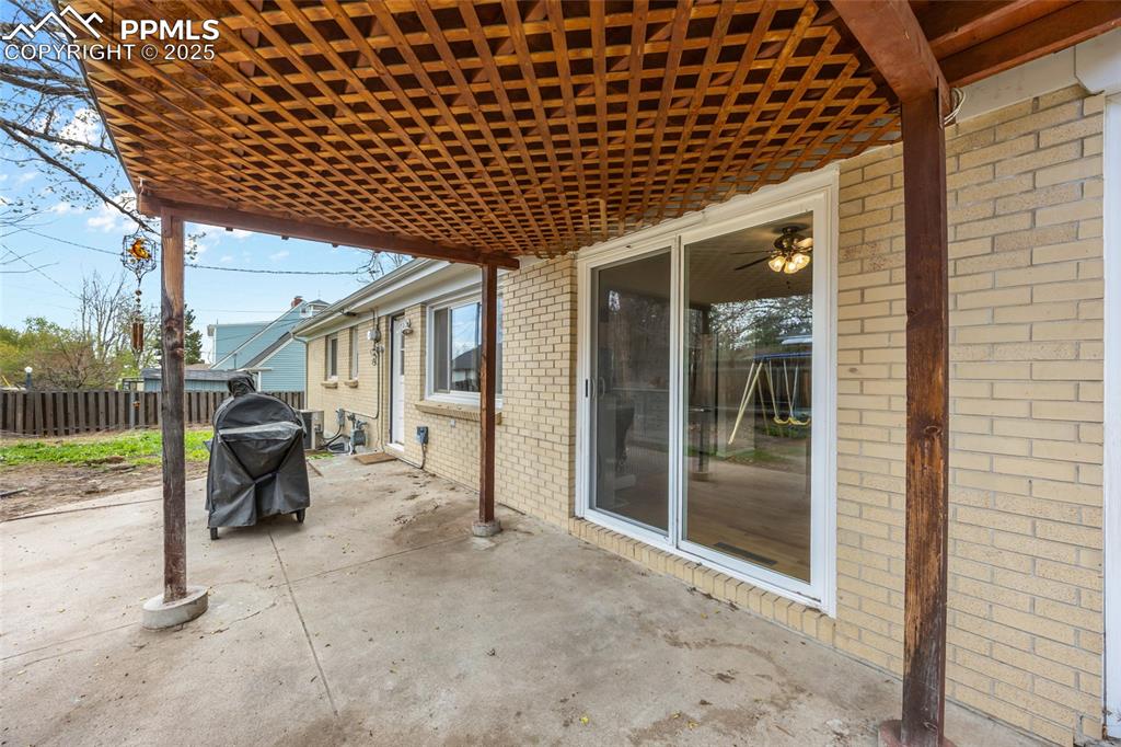 Image 35 of 39: View of patio featuring fence and grilling area