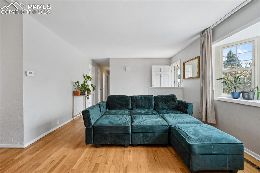 Image 7 of 39: Living area featuring light wood-style flooring and baseboards