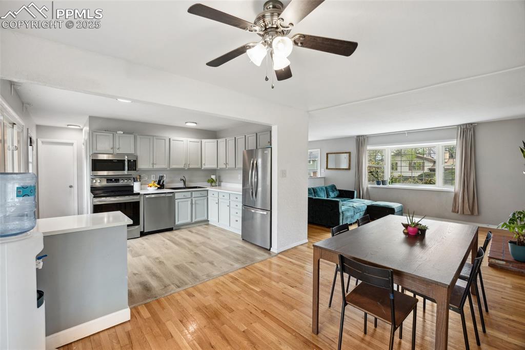 Image 8 of 39: Kitchen with a sink, stainless steel appliances, ceiling fan, gray cabinets