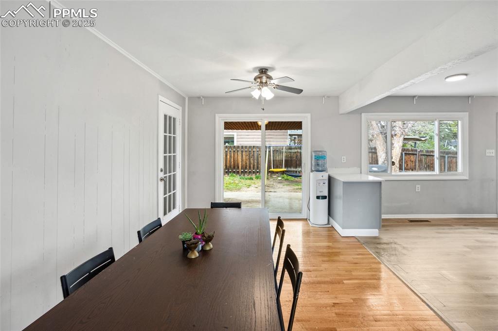 Image 9 of 39: Dining space with ceiling fan, light wood finished floors, and baseboards