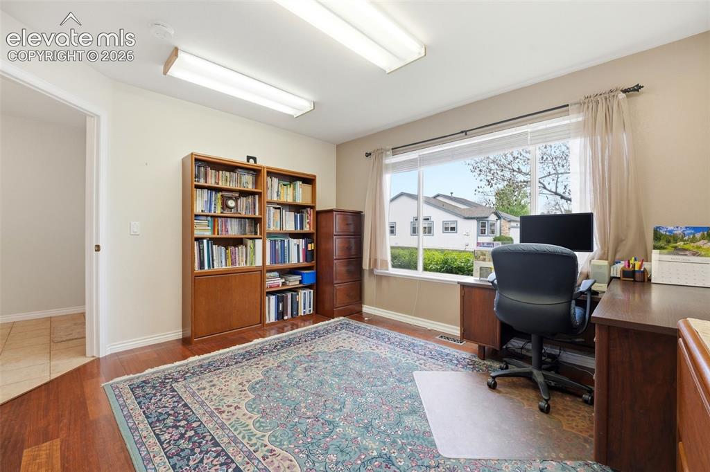 Image 20 of 47: Second bedroom on main level with walk in closet, currently used as an off