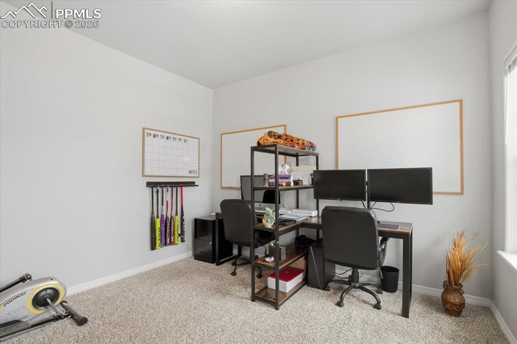Image 16 of 40: Carpeted home office with baseboards