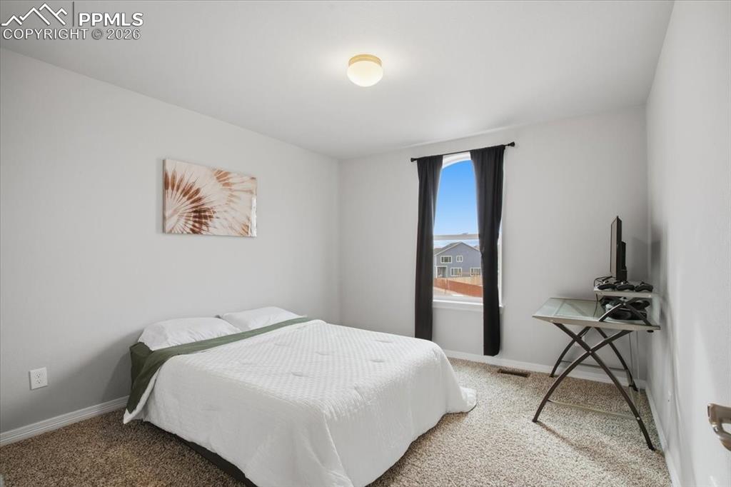 Image 21 of 40: Carpeted bedroom with baseboards