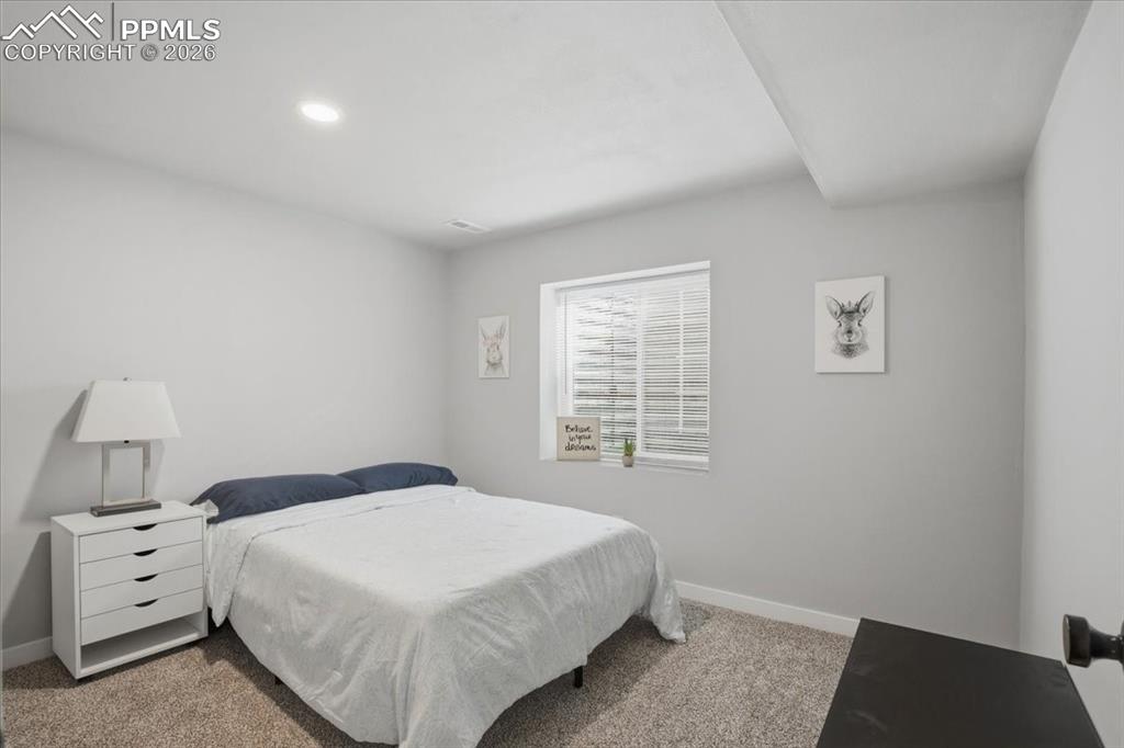 Image 28 of 40: Bedroom featuring light carpet and recessed lighting