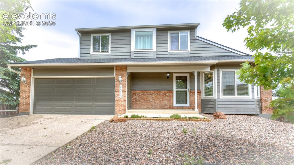 Image 1 of 41: Two-story residence featuring a combination of brick and horizontal siding