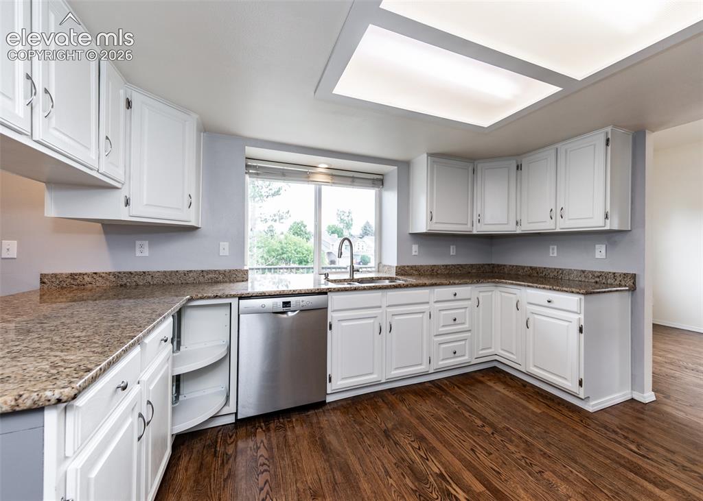 Image 15 of 41: Kitchen featuring abundant white cabinetry, granite countertops, a stainles