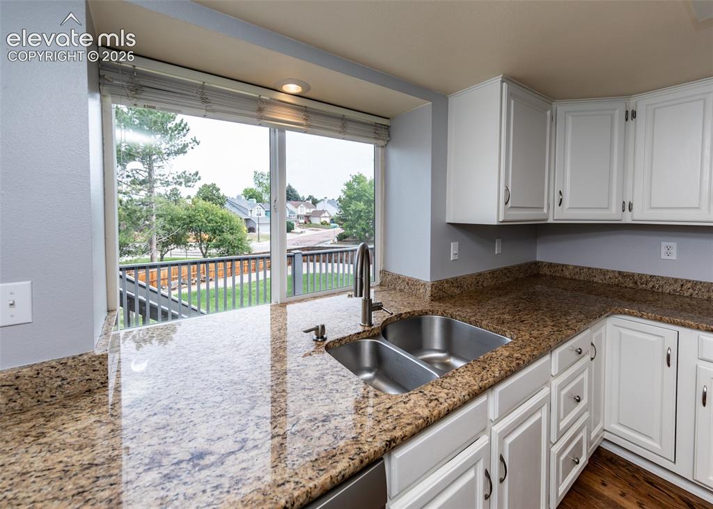 Image 16 of 41: Kitchen featuring granite countertops, a dual basin stainless steel sink wi