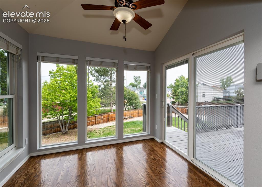 Image 20 of 41: Sunroom with vaulted ceiling, wood-finish flooring, a ceiling fan with inte
