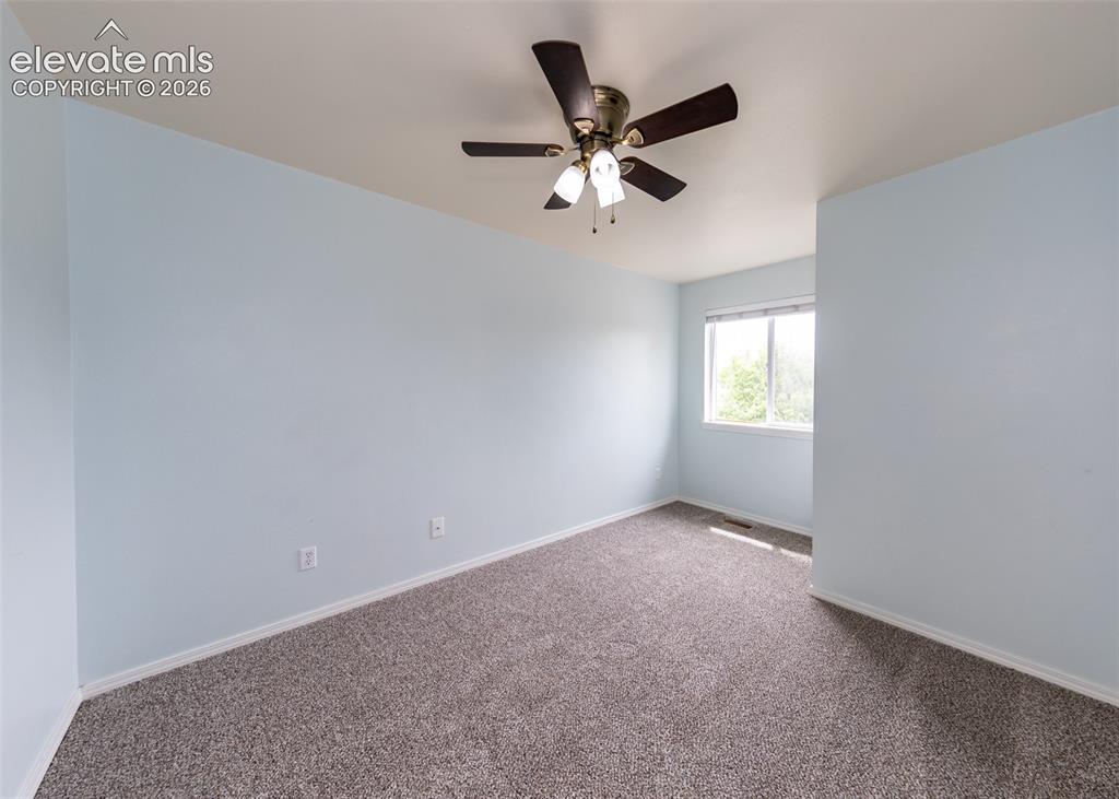 Image 28 of 41: Carpeted interior space with light blue walls and a white ceiling