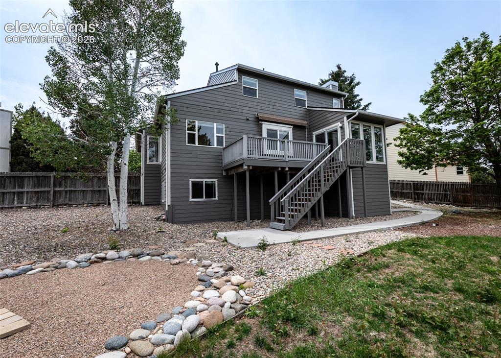 Image 41 of 41: Two-story residence featuring gray siding and white trim