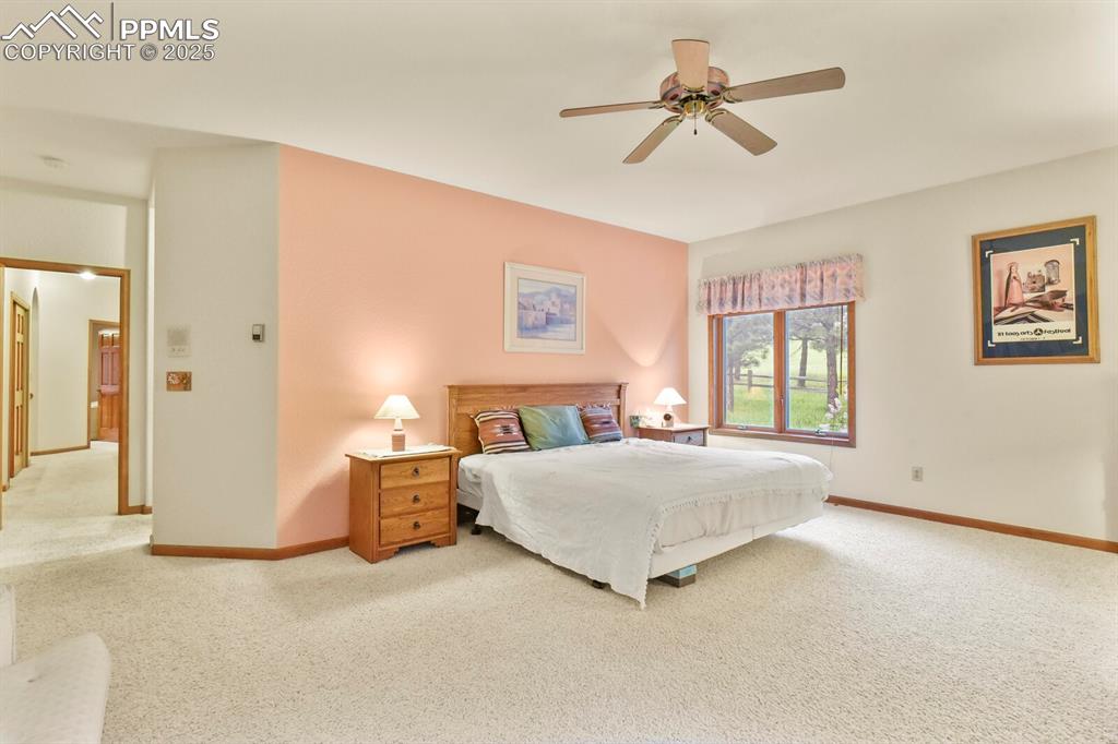 Image 19 of 48: Carpeted bedroom featuring baseboards and ceiling fan