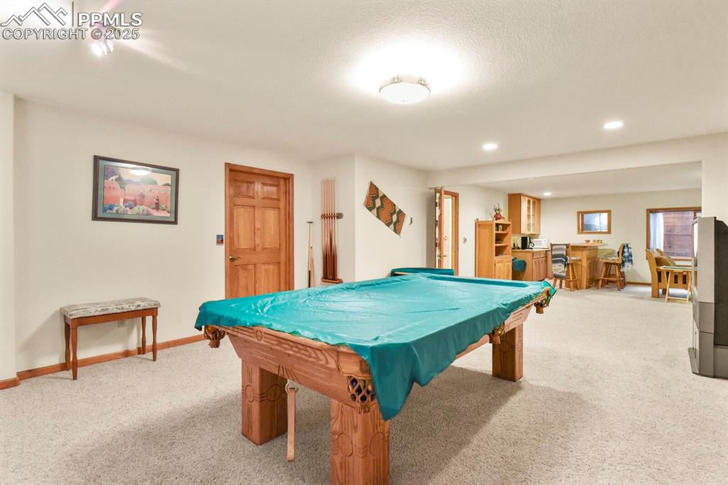 Image 31 of 48: Rec room with carpet, pool table, recessed lighting, a textured ceiling, an
