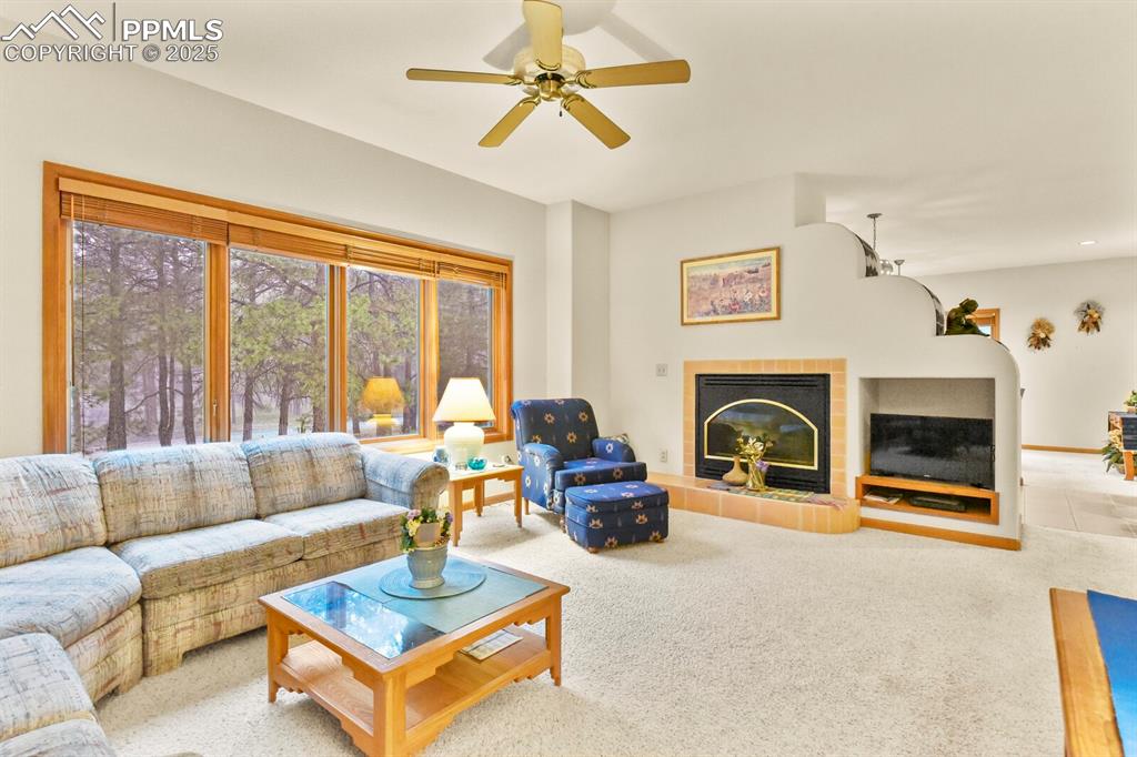 Image 7 of 48: Carpeted living room featuring ceiling fan