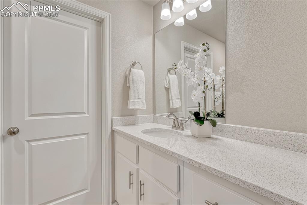 Image 17 of 29: Primary 3/4 bath with quartz countertop...